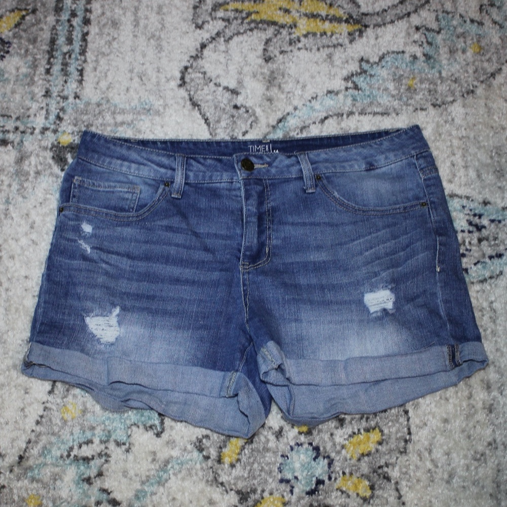 Medium-dark denim distressed frayed and cuffed jean shorts
